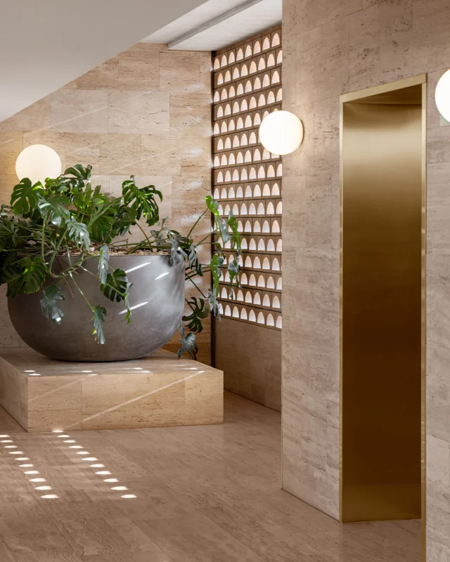 Geometric stonework, golden hues, and verdant greenery. Our lift landings invite moments of quiet reflection.